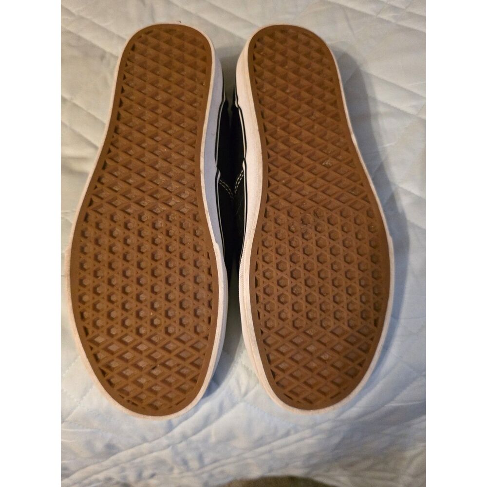 These are black Vans Authentic sneakers with white laces. - Picture 3 of 9